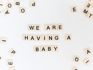 Photo by Sincerely Media Scrabble tiles arranged to spell 'We Are Having a Baby,' celebrating successful results from top infertility solutions.